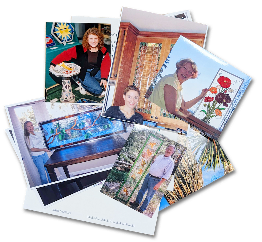 Artists posing beside their stained and fused glass pieces